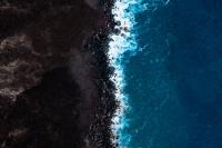 Intersection of the ocean and soil farming land.