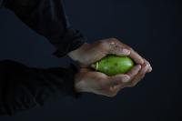 Woman holding a fruit.