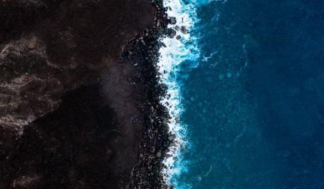 Intersection of the ocean and soil farming land.