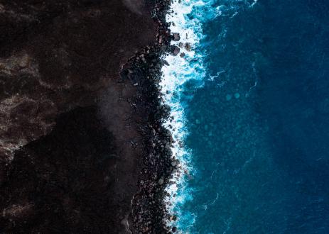 Intersection of the ocean and soil farming land.