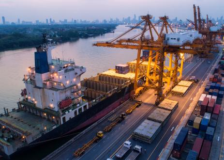 Busy shipping port outside of a city.